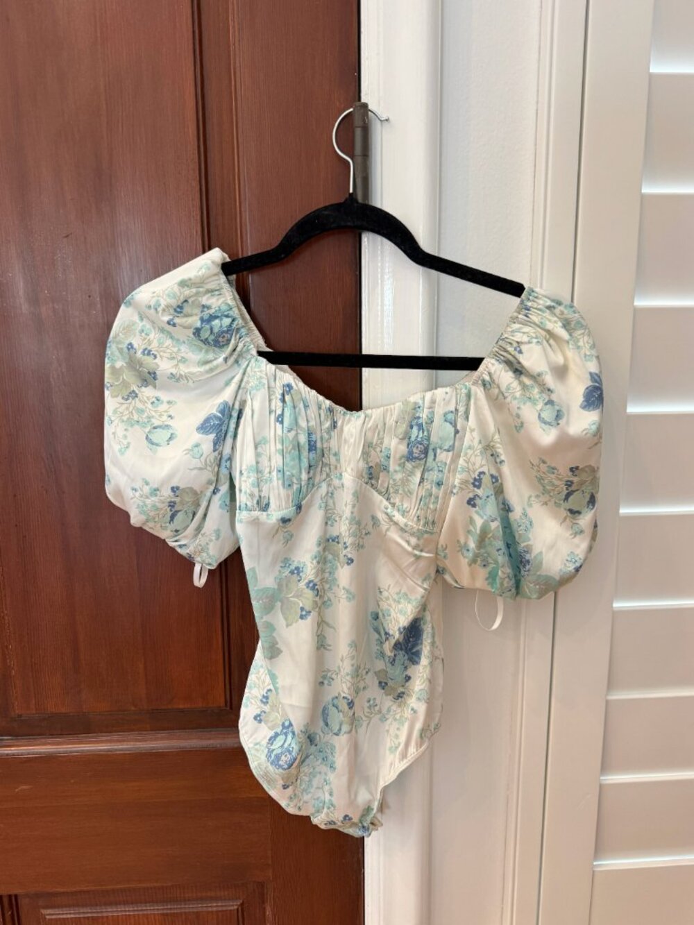 For Love & Lemons Danny Bodysuit in White and Blue Floral Design.